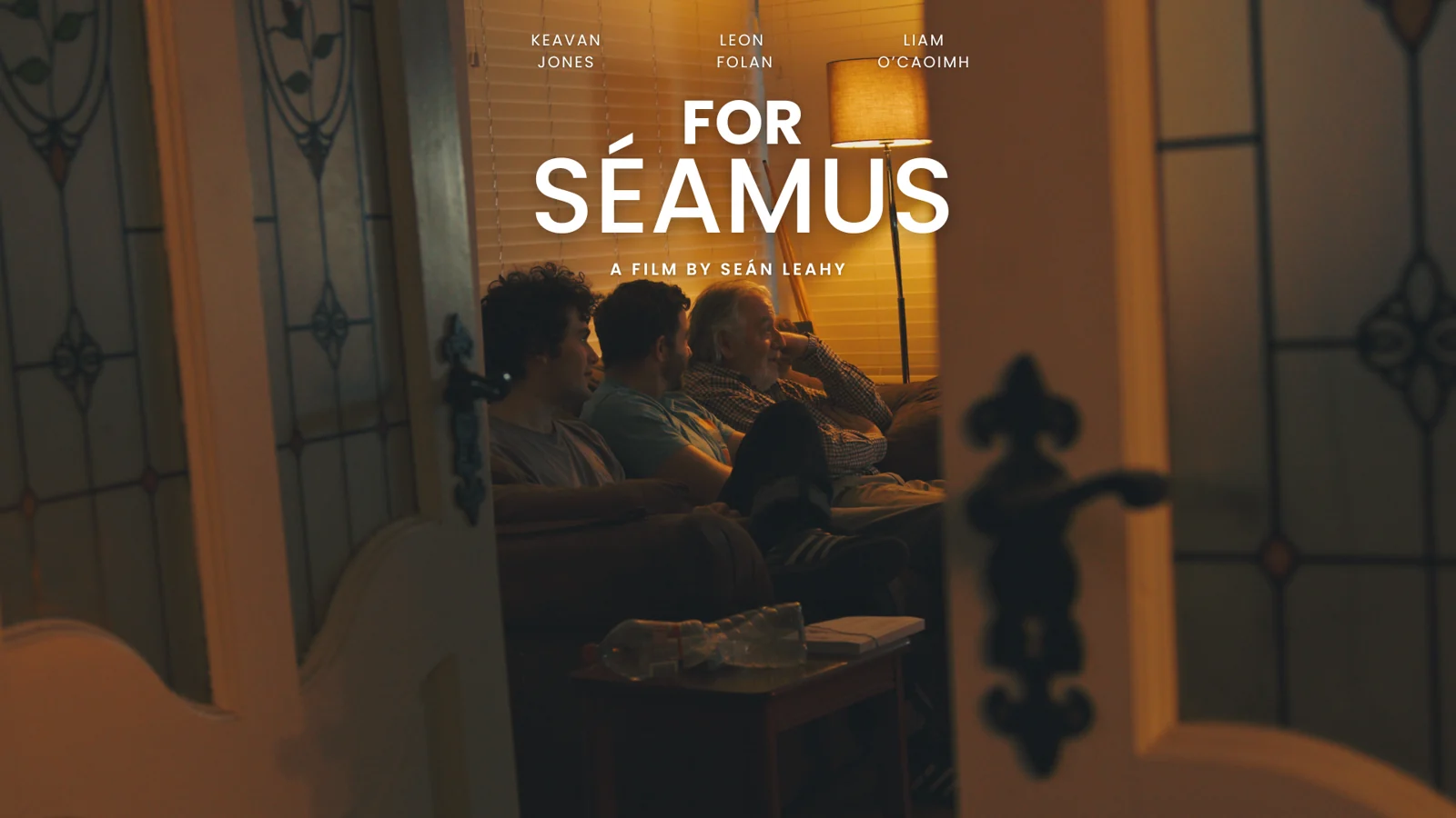 Official For Séamus poster, with the film title above two people seated in a warmly lit room.